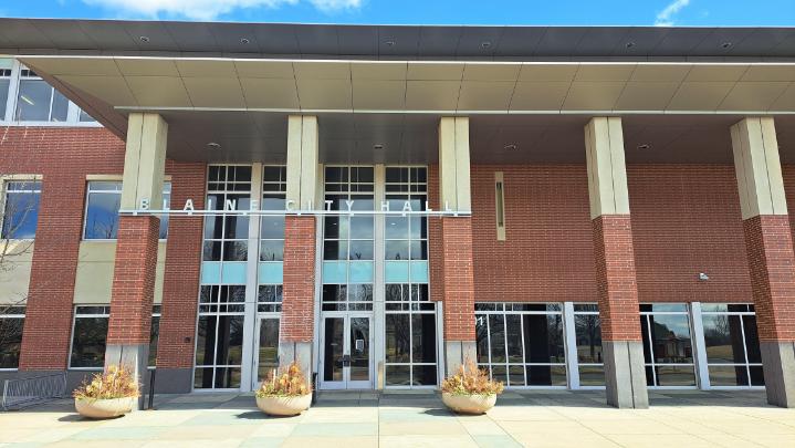 Front view of Blaine City Hall showing the main entrance and building signage on a clear day.